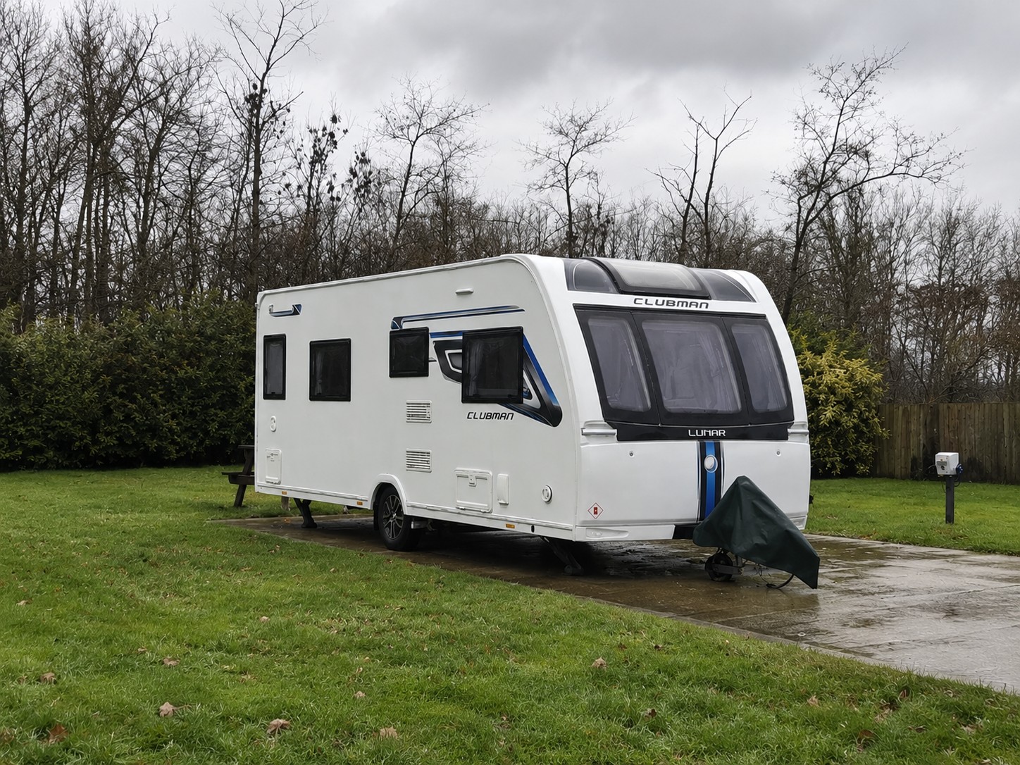 Caravan sited on grass on a cloudy day