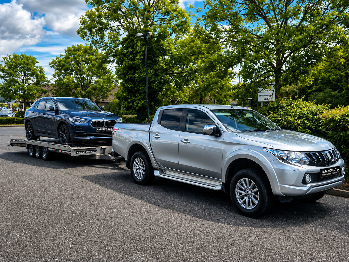 Pickup towing a trailer with a vehicle